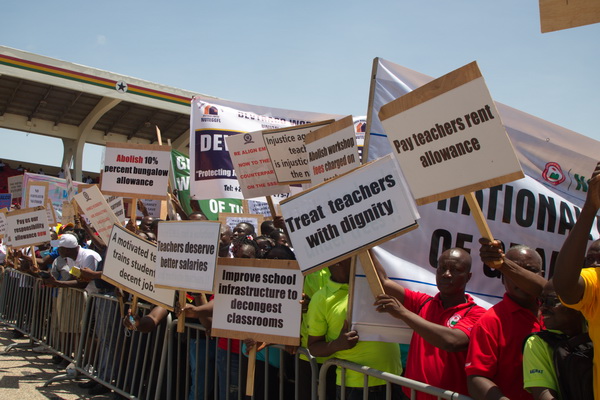 A section of teachers at the 2022 celebration of May Day bearing placards of some of their demands